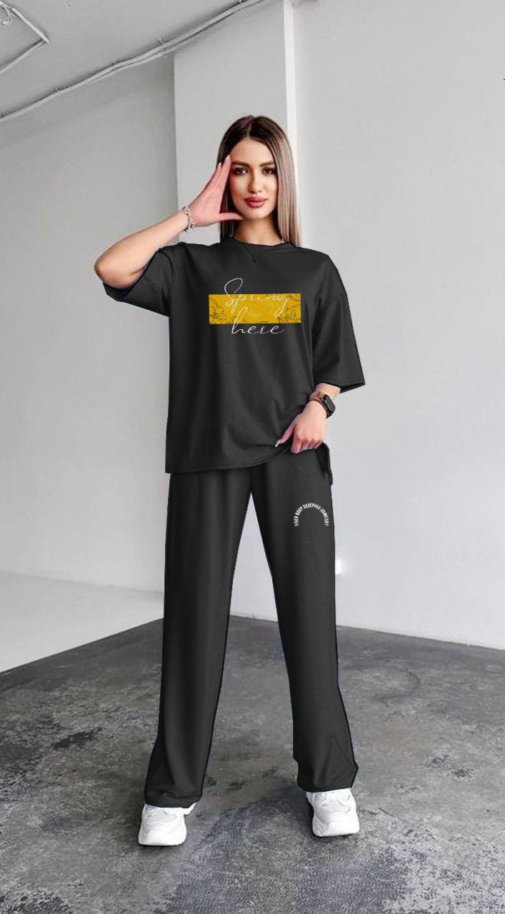 Woman wearing a black outfit with text and 'Vloria's Secret' branding.