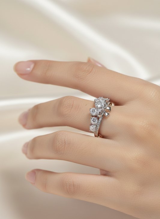 Hand wearing a diamond ring on a light background