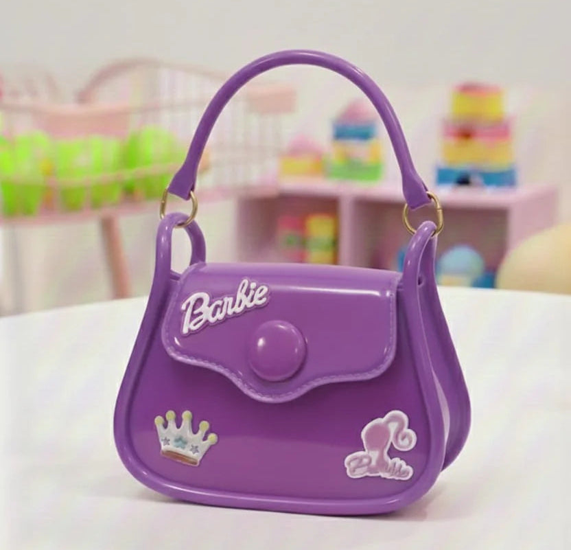 Purple Barbie handbag on a white surface with a blurred colorful background